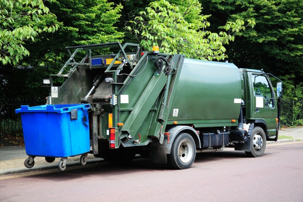 A refuse truck picking up a bin. We're training our drivers to prevent danger to people sleeping rough in refuse containers.
