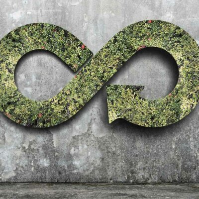 A circular economy sign on a concrete wall