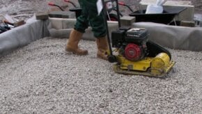 Sub base layer aggregate being compacted