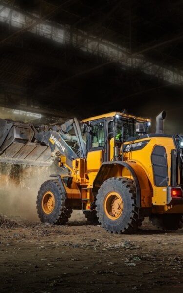 Excavator moving waste at North West Recycling